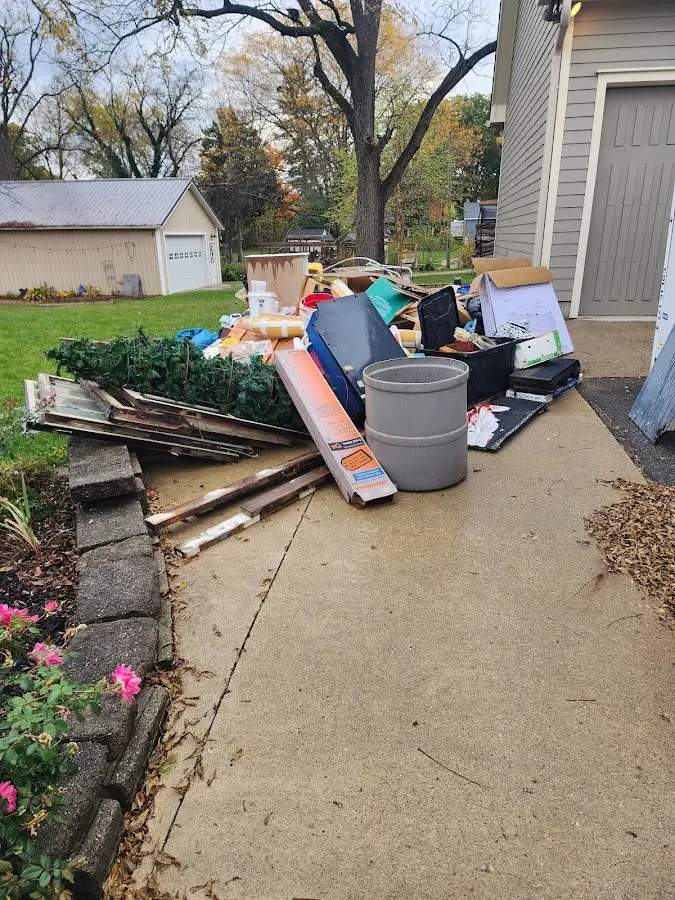 Dumpster being loaded with debris for Estate Cleanout Dumpster Rental in West Haven